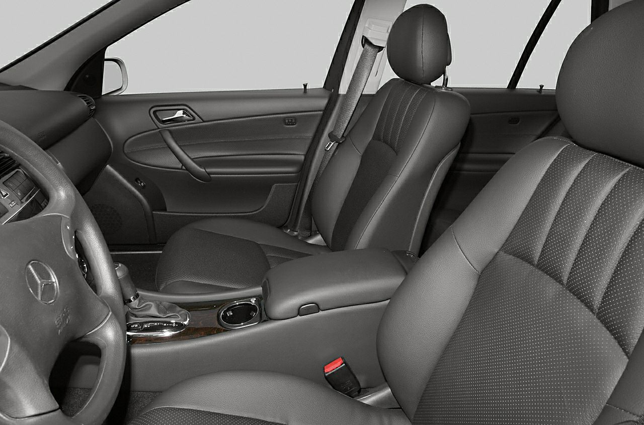 Front interior seats and dashboard of mid-2000s vehicle