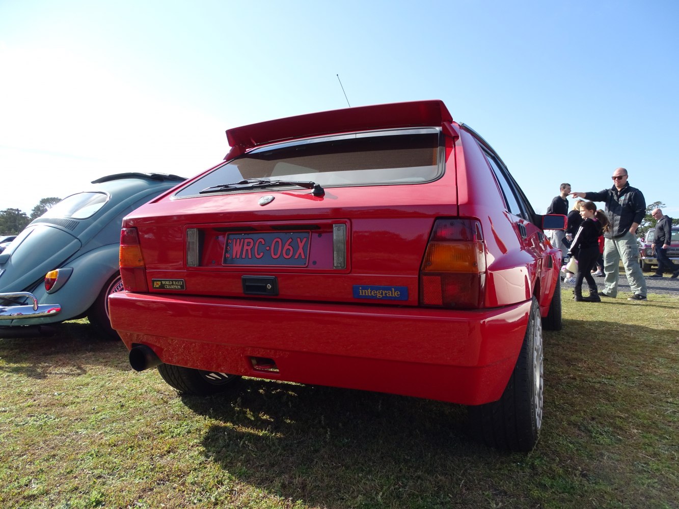 Red hatchback rear with wide spoiler and rally badges