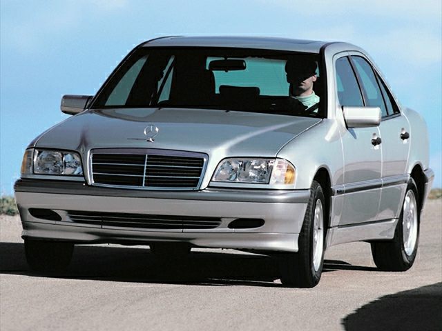Front and side view of a classic sedan with distinct headlight and grille design.