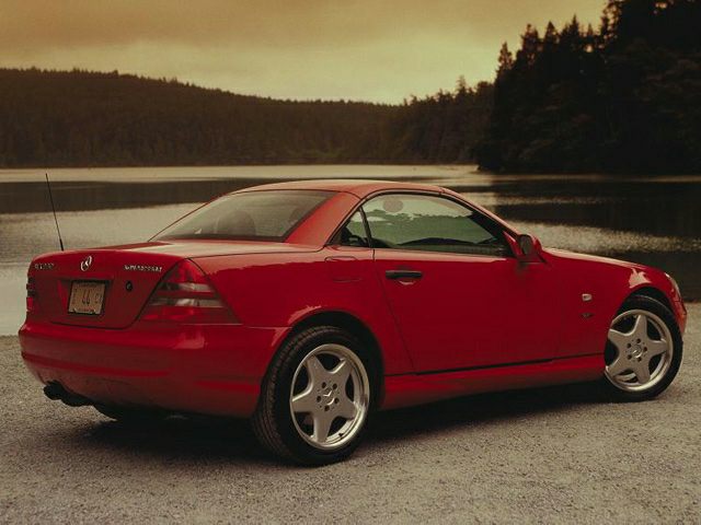 Red hardtop convertible with alloy wheels and sleek design.