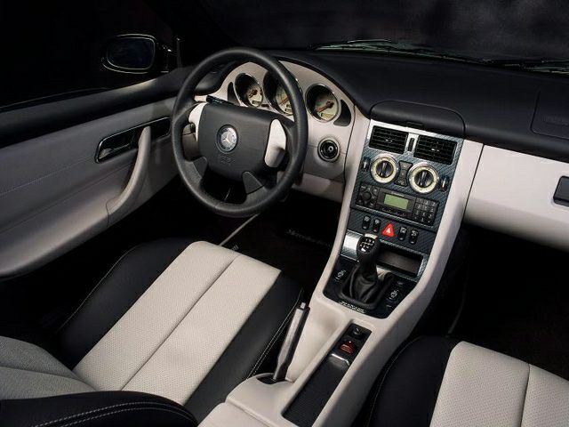 Dashboard, steering wheel, and center console of a classic late 1990s roadster