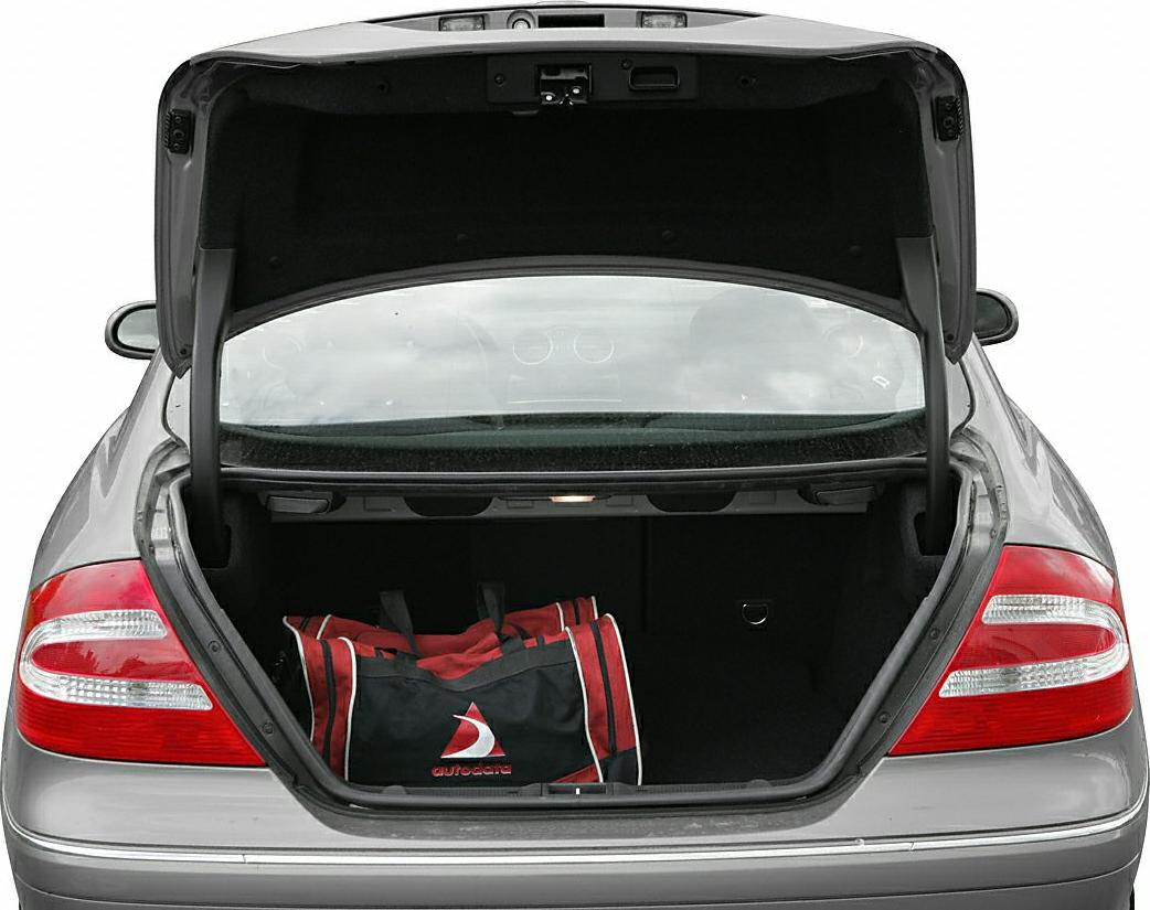 Open trunk with travel bag and rear lights of luxury coupe