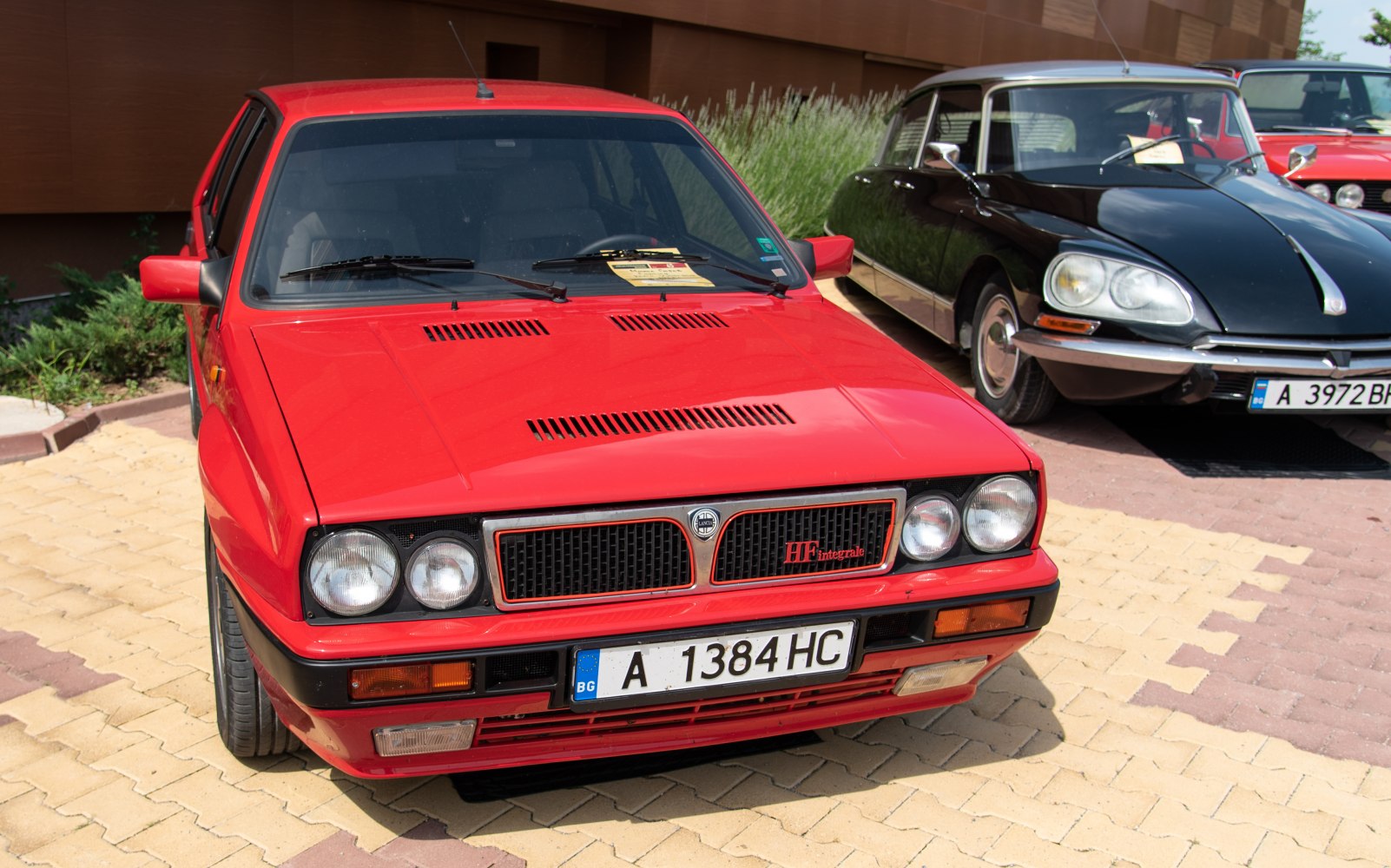 Red front view with dual round headlights and aggressive grille