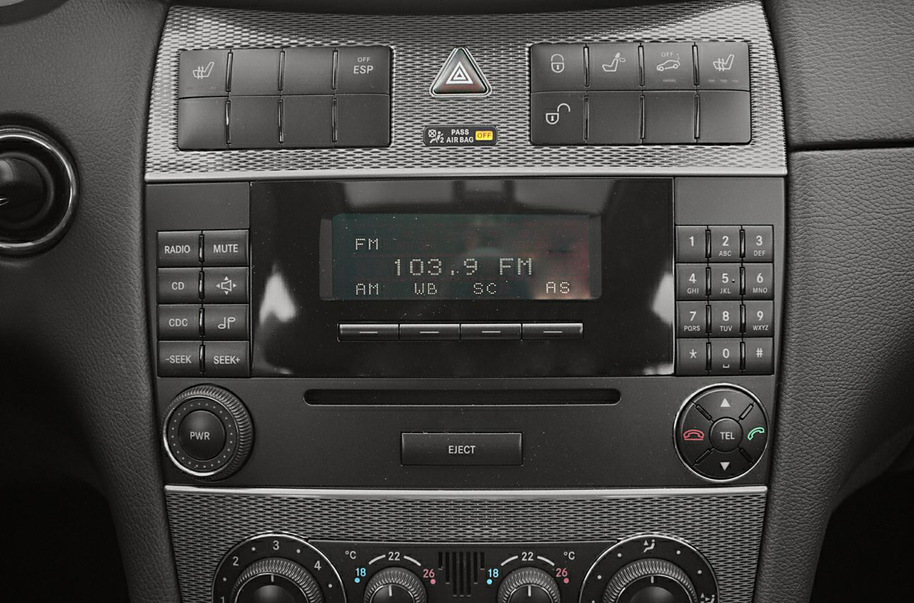 Car dashboard control panel with radio, climate, and seat adjustment buttons