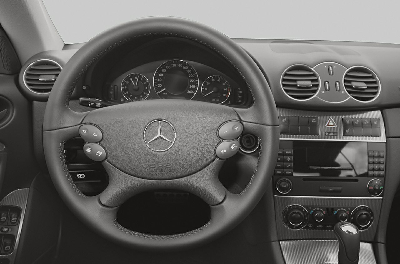 Steering wheel and dashboard with instrument cluster and control buttons