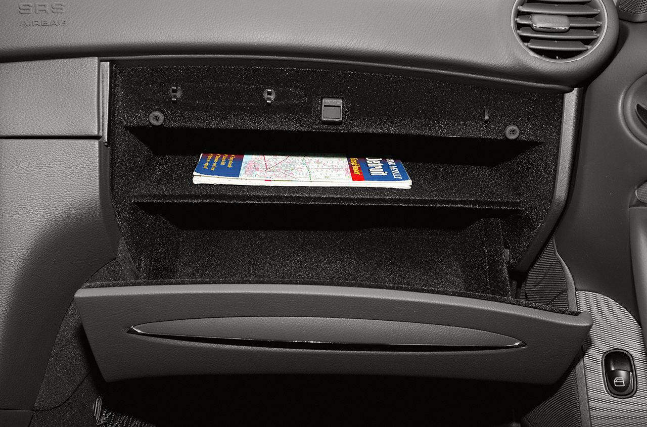 Open glovebox storage compartment in car interior