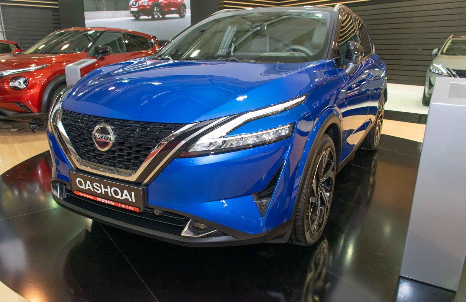 Sharp LED headlights and front grille of a blue SUV