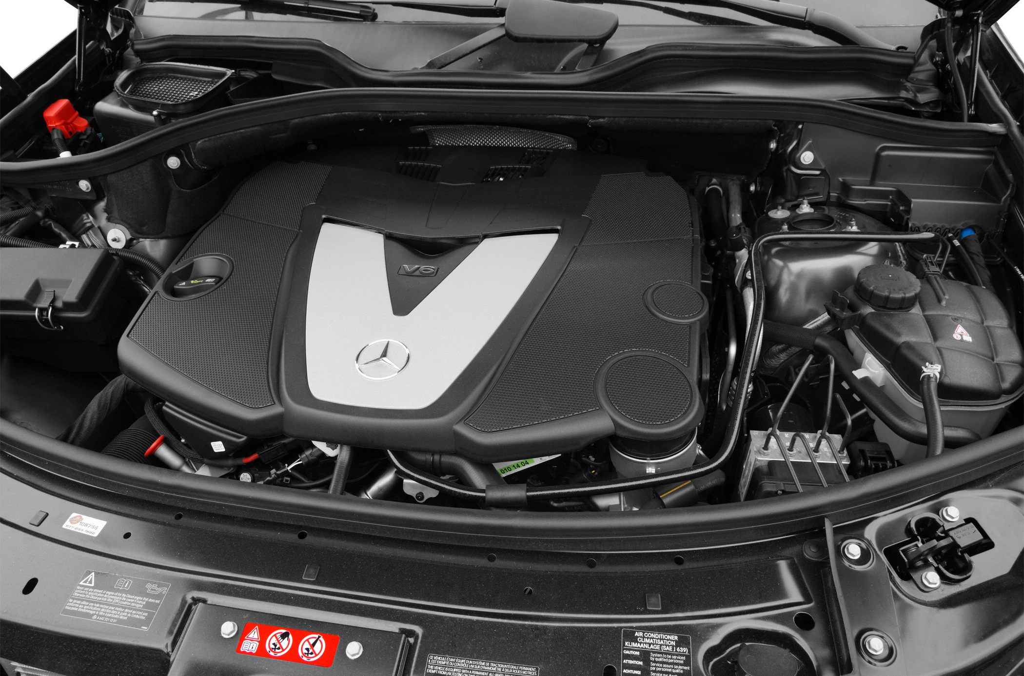 Close-up of V6 engine bay with Mercedes-Benz emblem and surrounding components