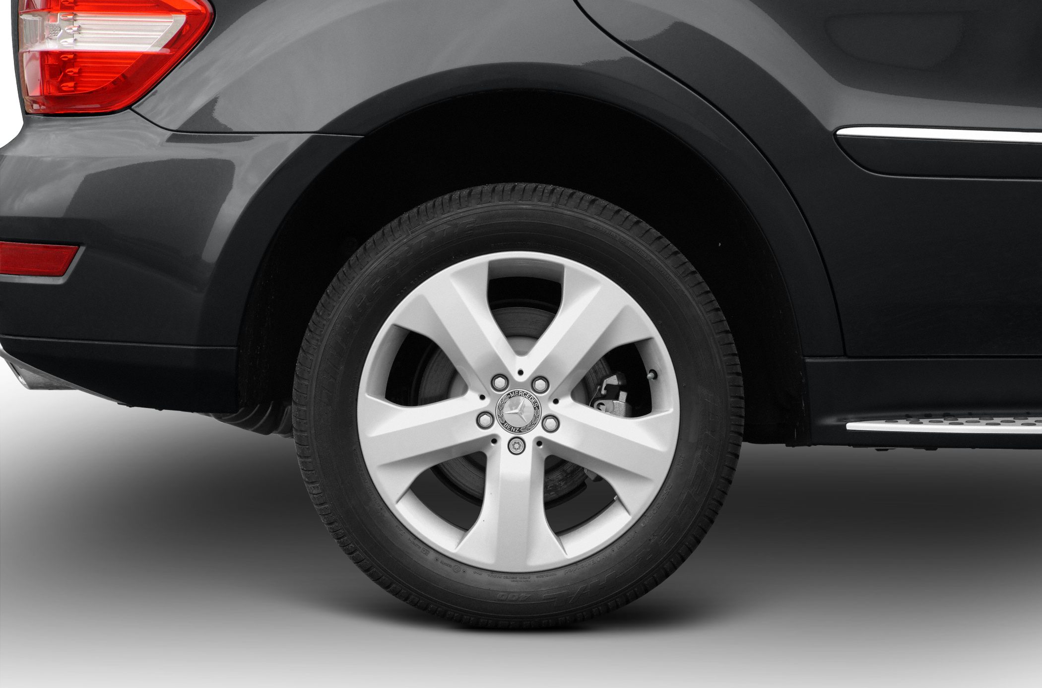 Five-spoke alloy wheel and rear side panel with taillight and trim