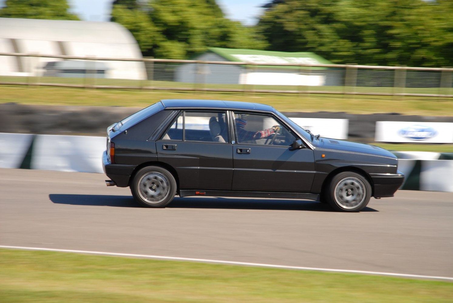 Side profile of a classic hatchback in motion
