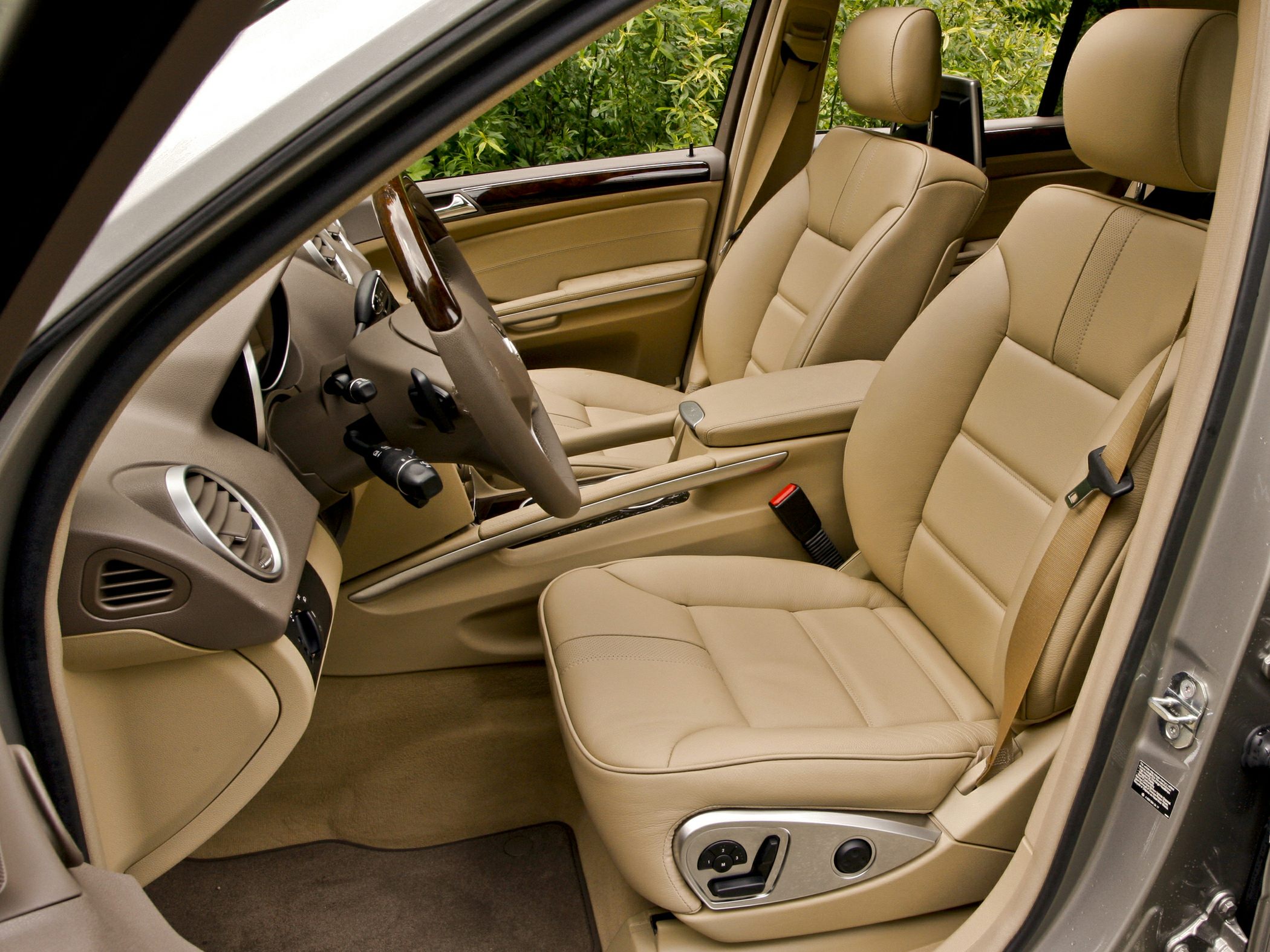 Beige leather front seats with adjustable controls and luxury interior trim