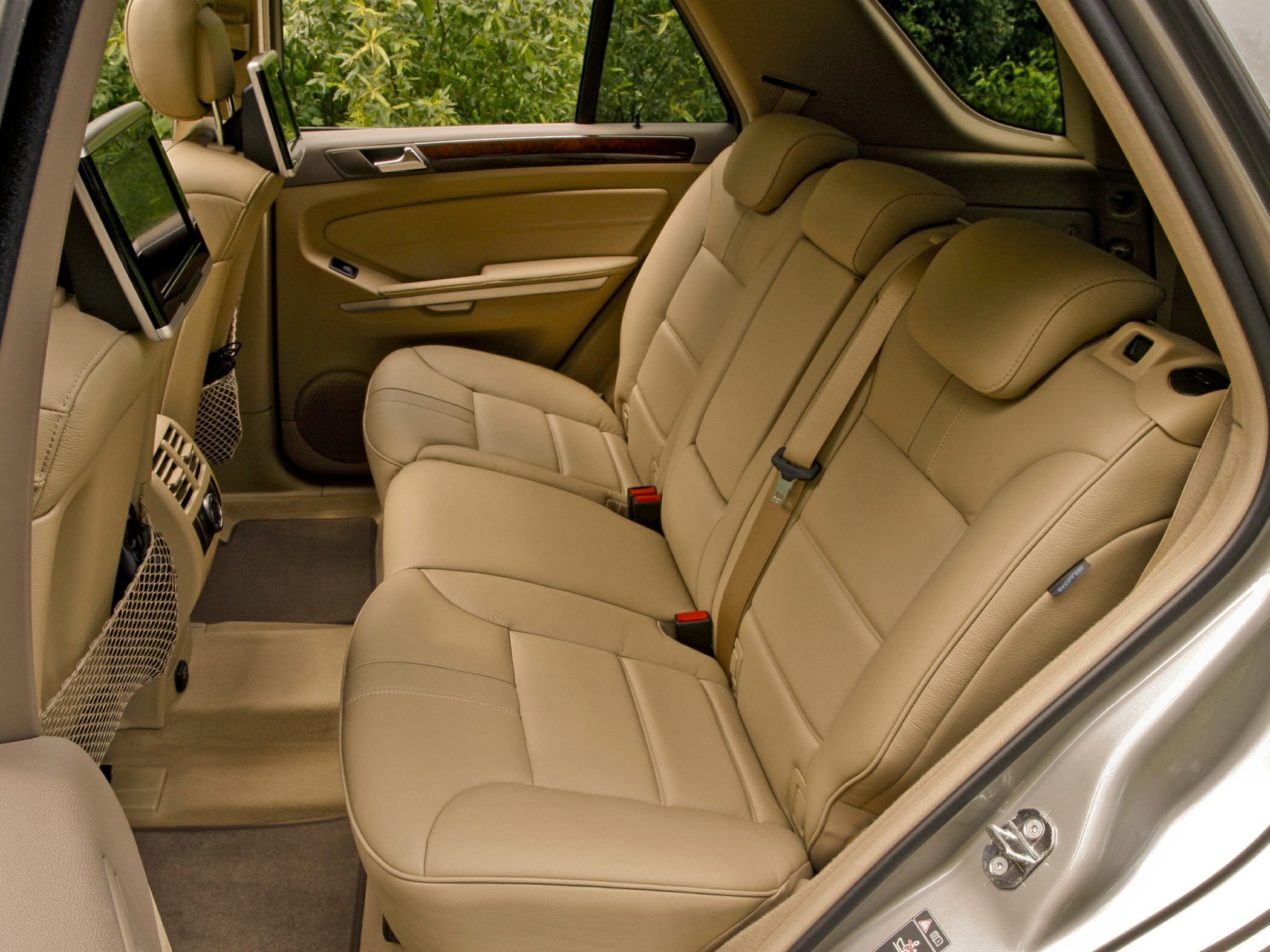 Beige leather rear seats with entertainment screens