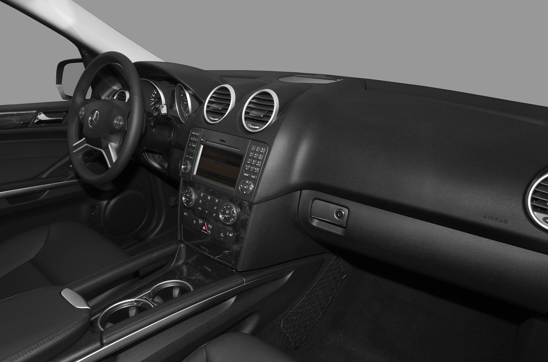 Interior dashboard and steering wheel with central infotainment and air vents
