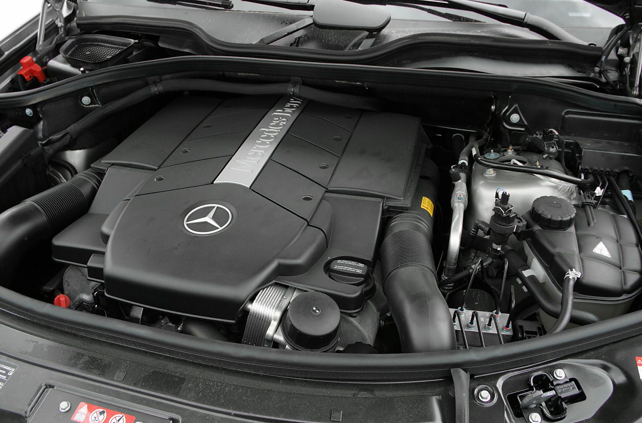 Mercedes-Benz engine bay with prominent engine cover and components.