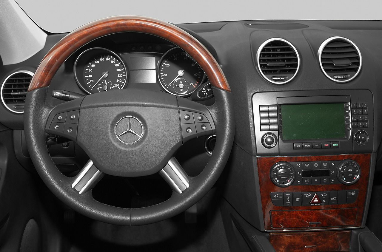 Steering wheel, dashboard, and infotainment controls with wood trim