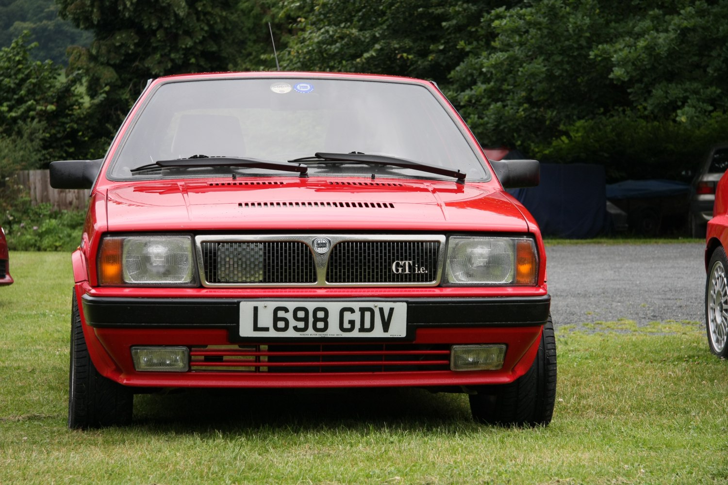 Front view with rectangular headlamps and trapezoidal grille with GT i.e. badge