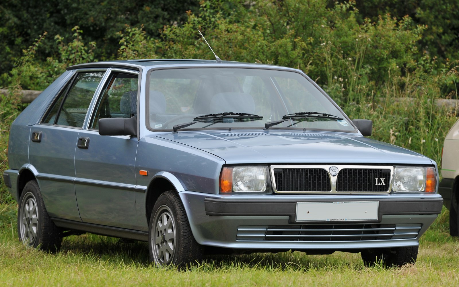 Front view of classic hatchback with dual windshield wipers and LX badge
