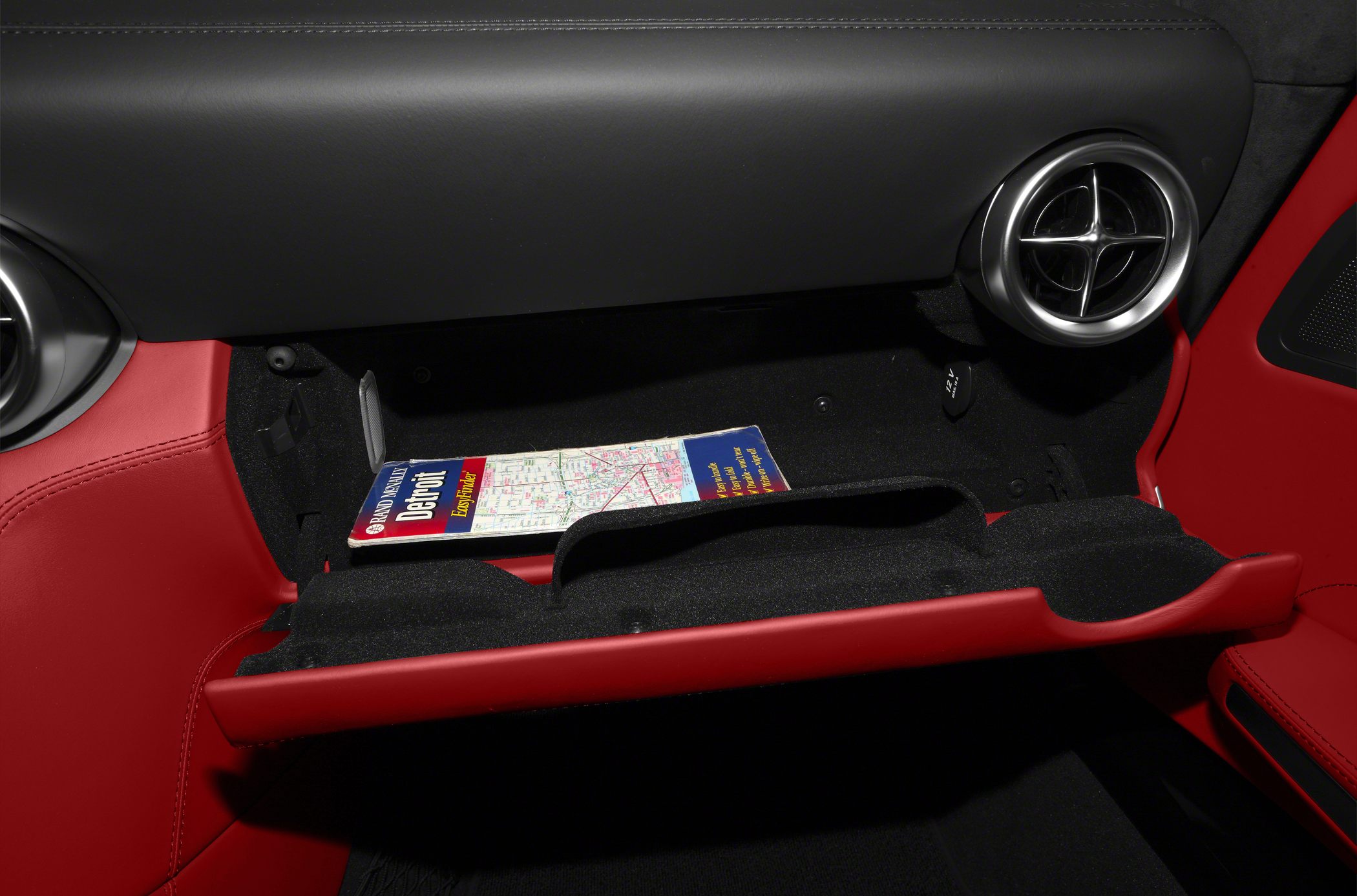 Luxury car glovebox with map and round air vent