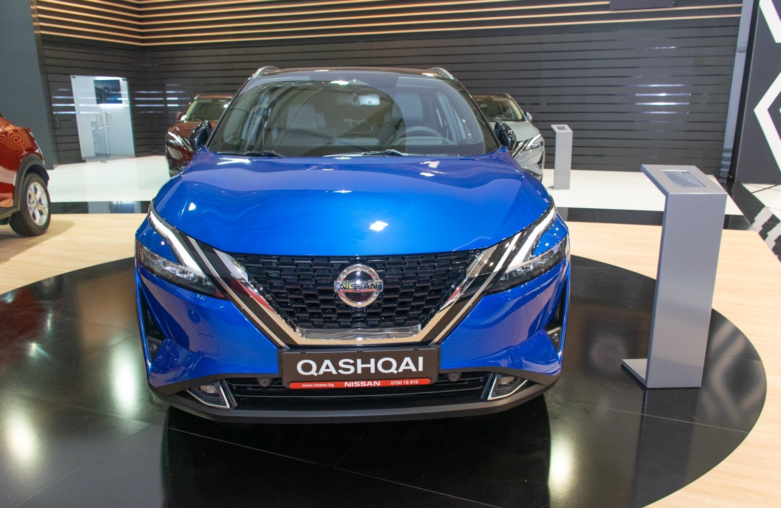 Blue SUV with modern grille and sleek LED headlights front view