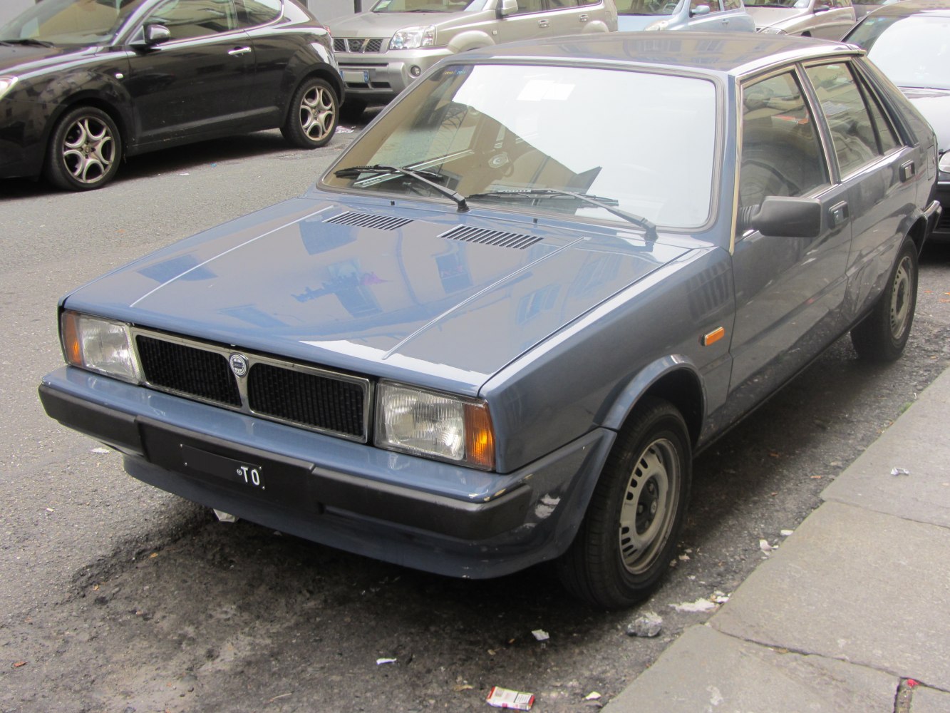 1980s angular hatchback front with rectangular headlights and classic grille