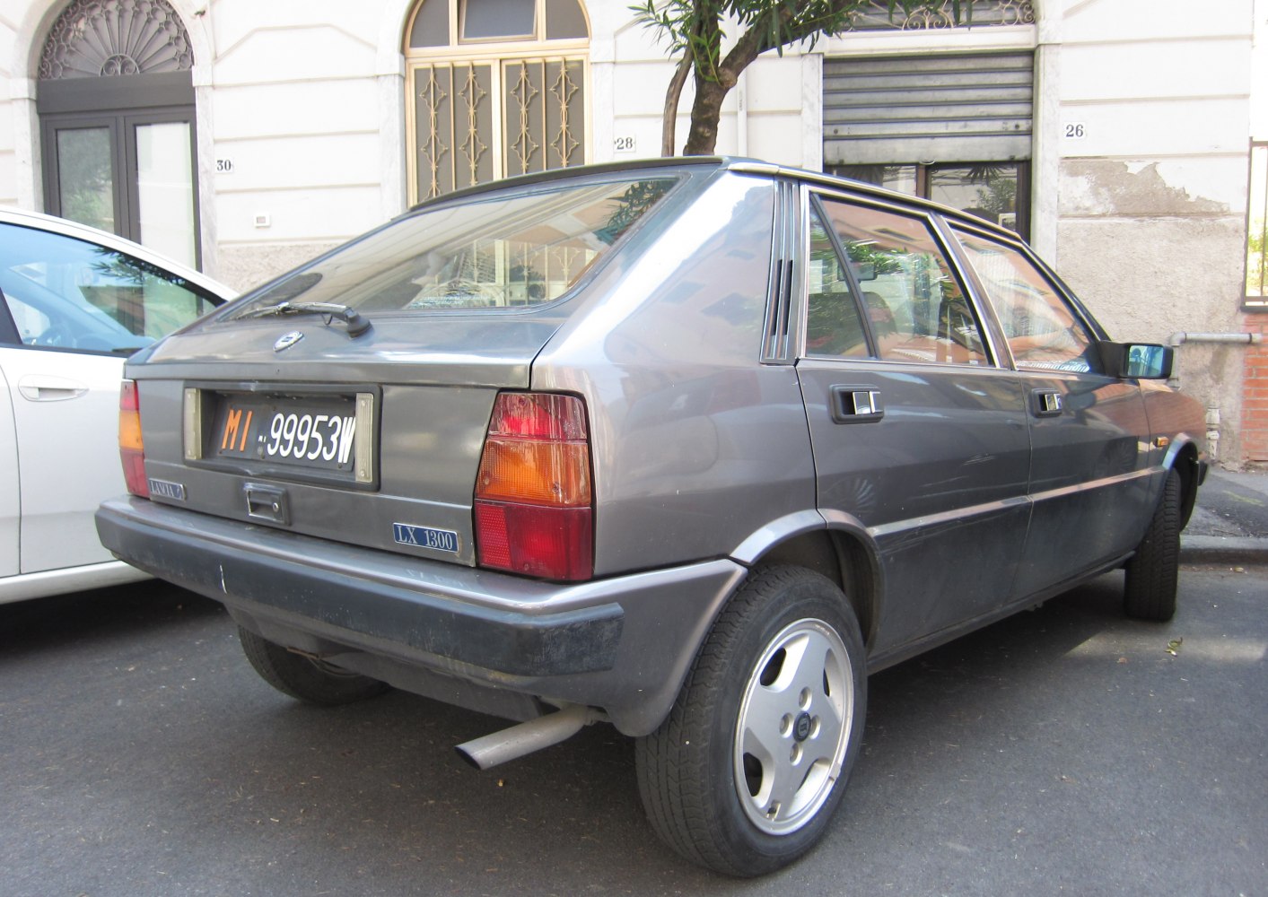 Sloped rear hatchback with rectangular taillights and alloy wheels