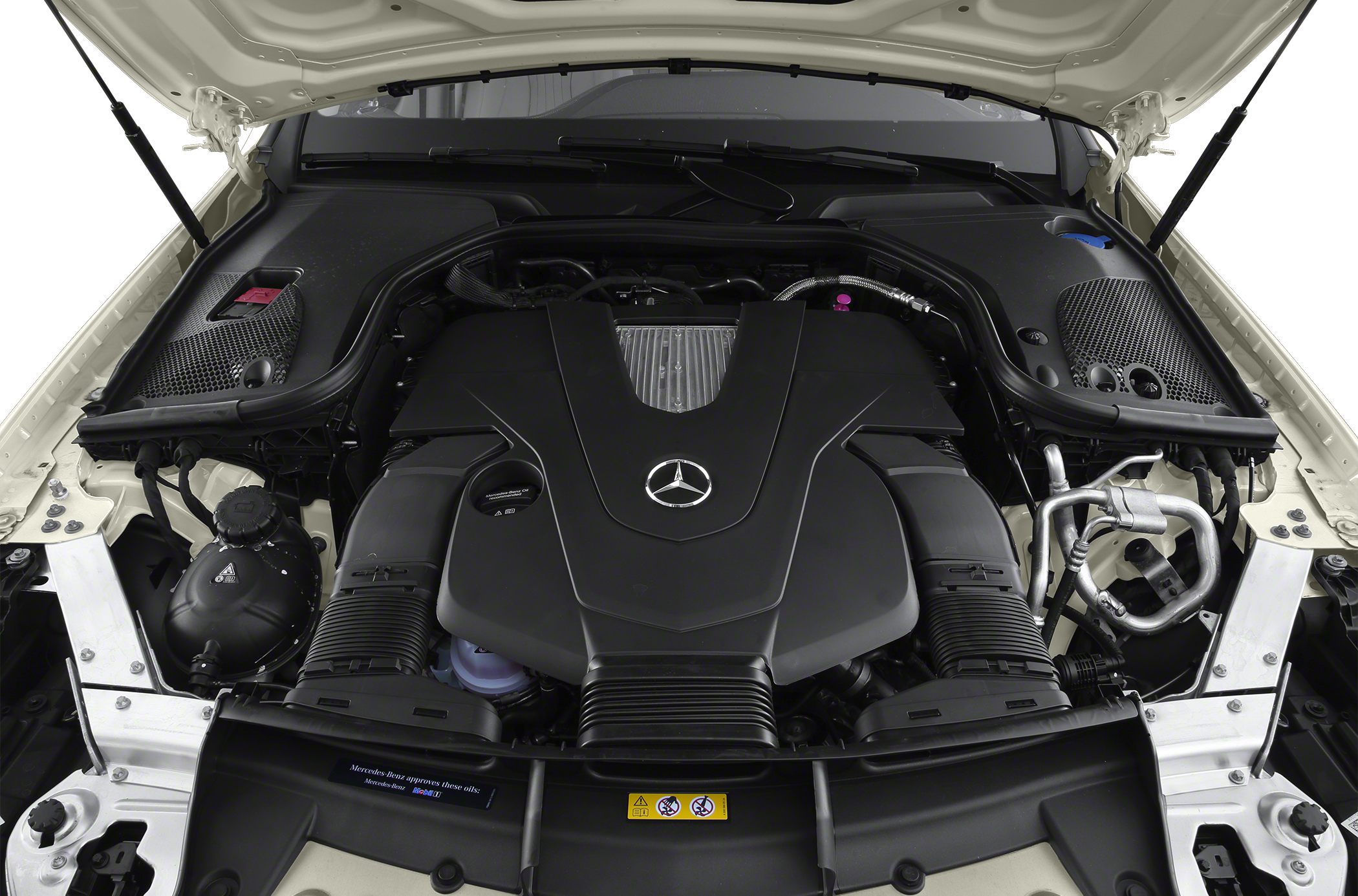 Engine bay with large black engine cover and visible components