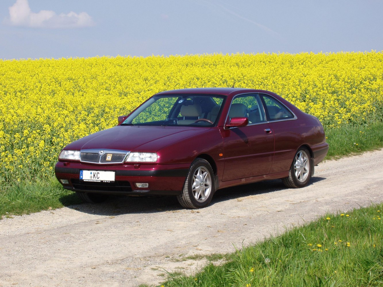 Red coupe with distinctive front grille and alloy wheels