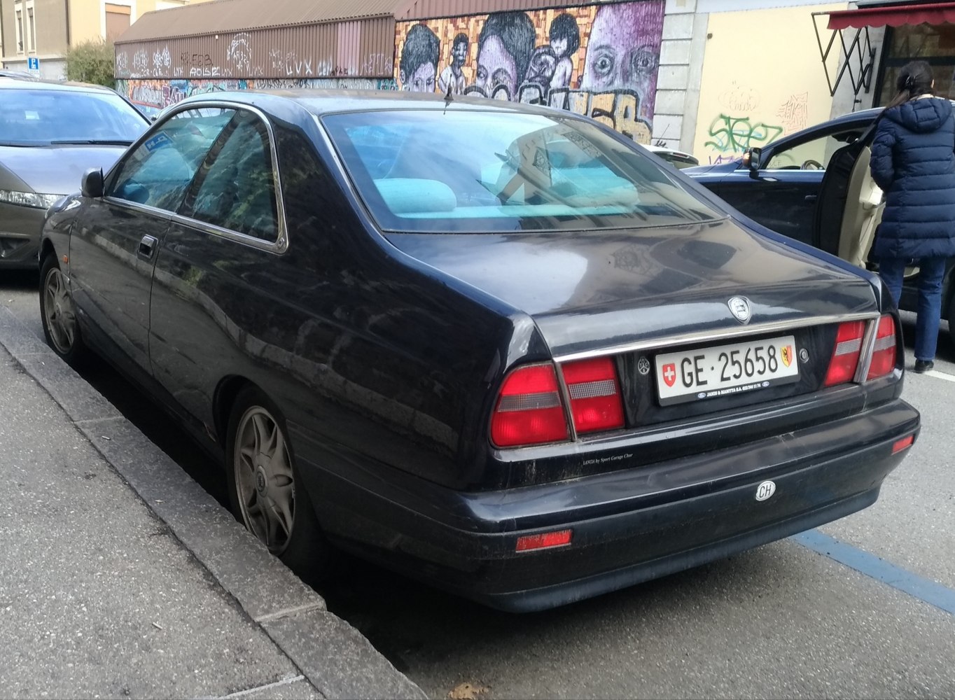 Rear view of a coupe with distinct tail lights and sloped rear design.