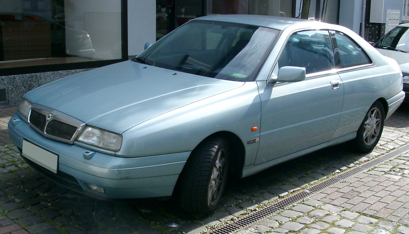 Front three-quarter view of a sleek coupe with alloy wheels