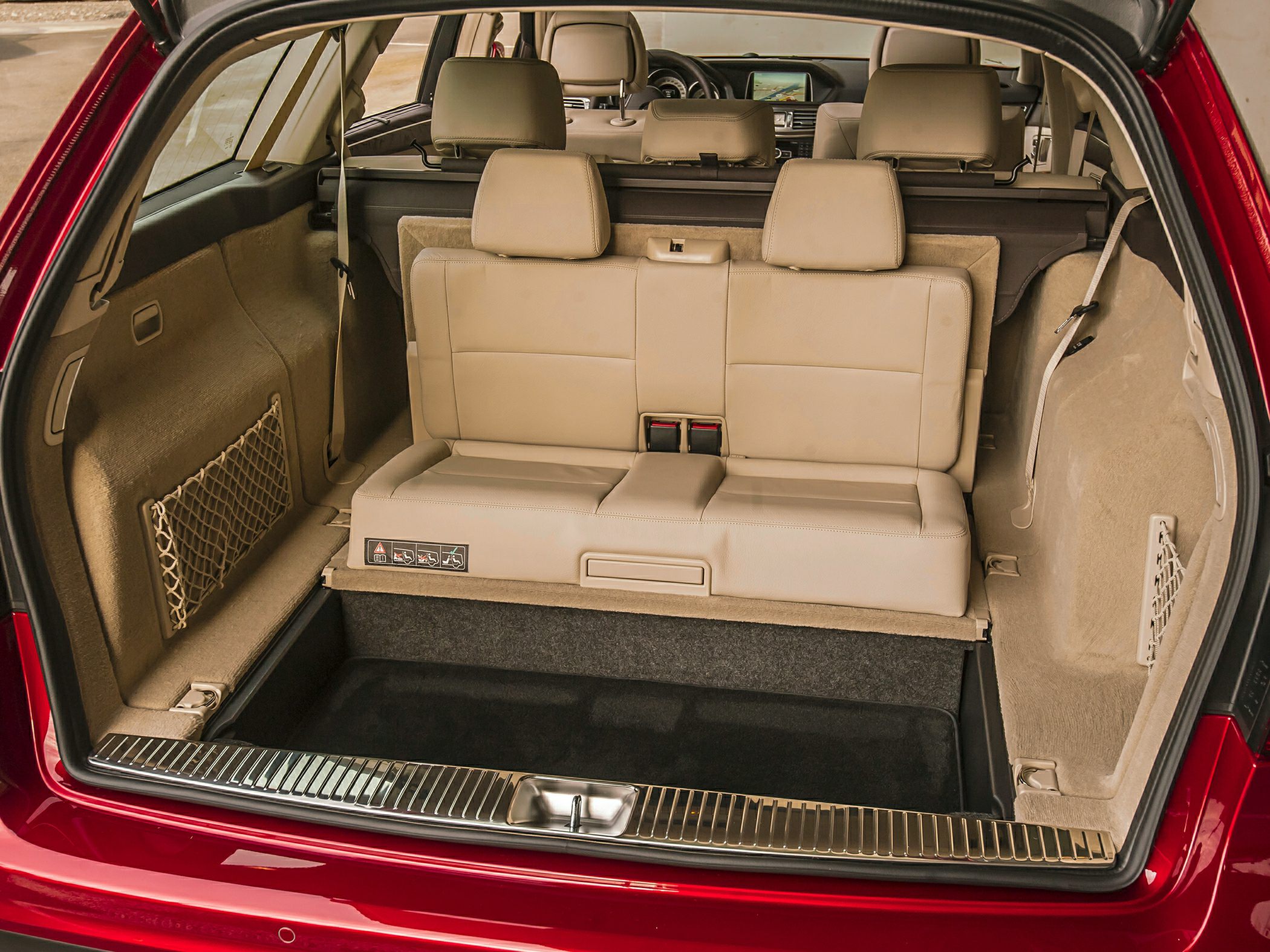 Rear third-row foldable seats and cargo space with beige interior