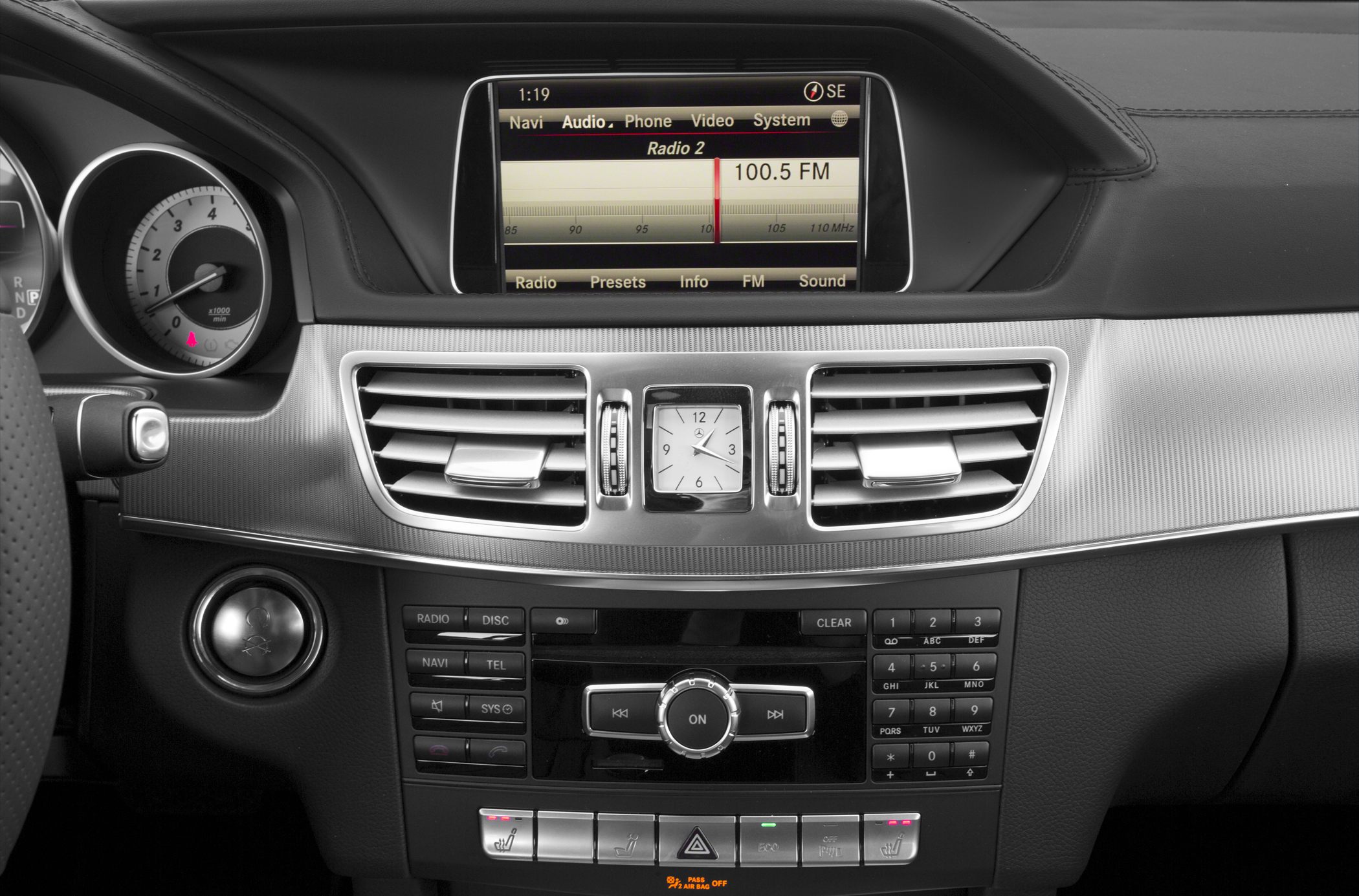 Dashboard console with analog clock and media control panel