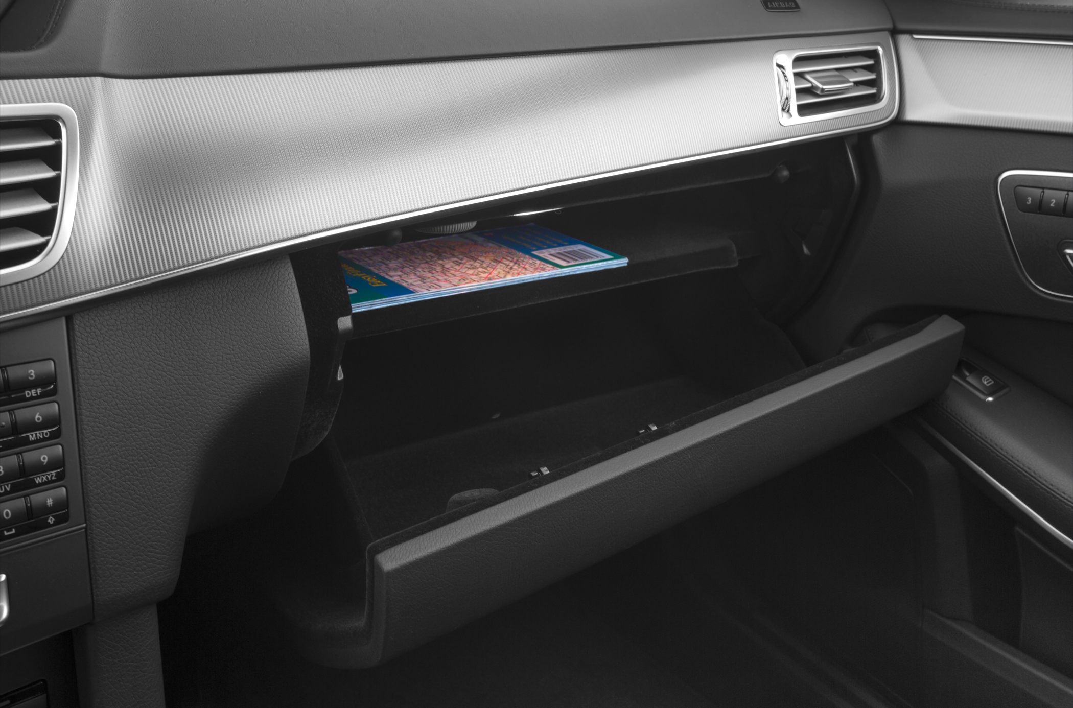 Open glove compartment with storage shelf and map inside