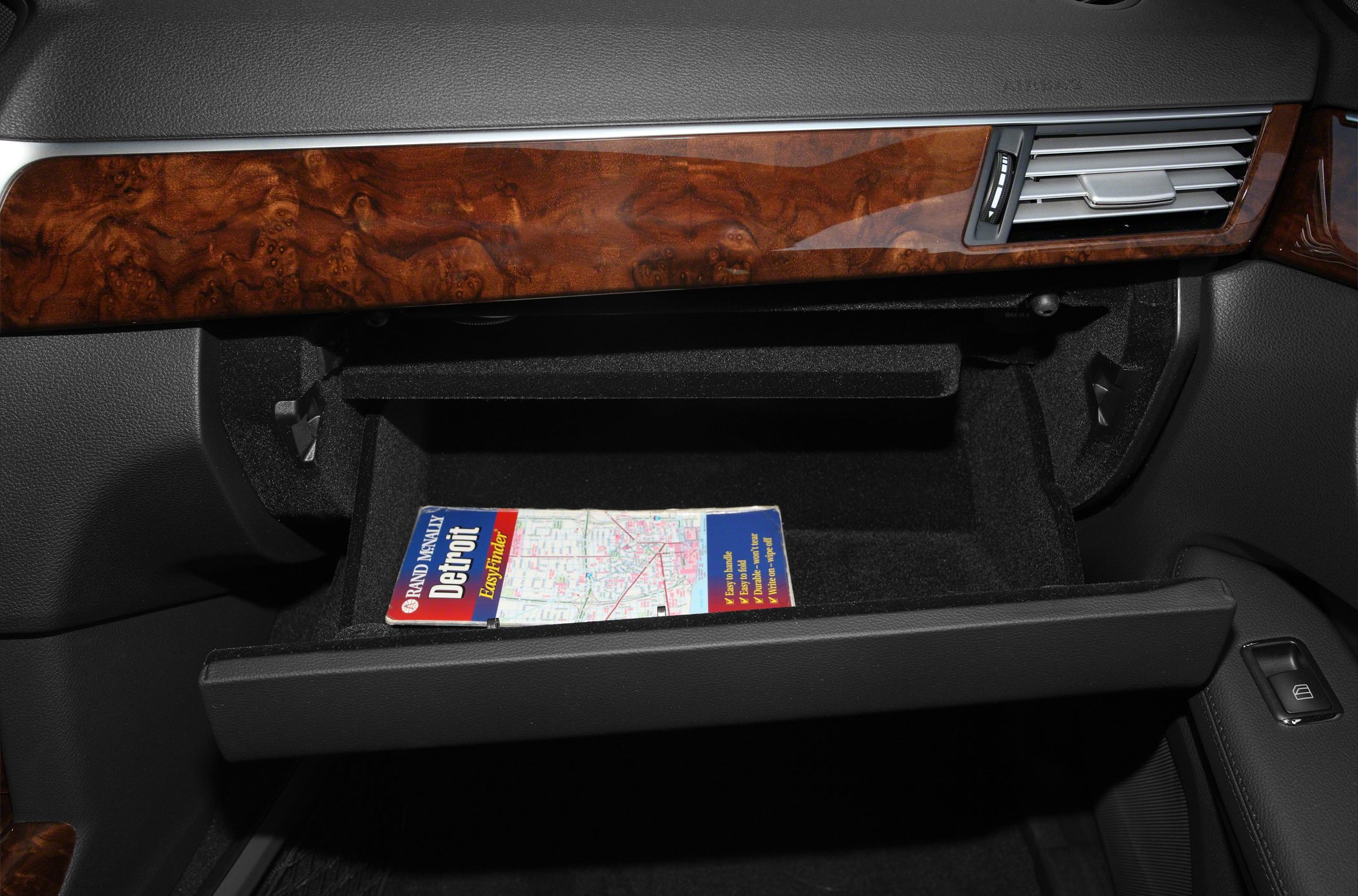 Glove box with wood trim and dashboard air vent