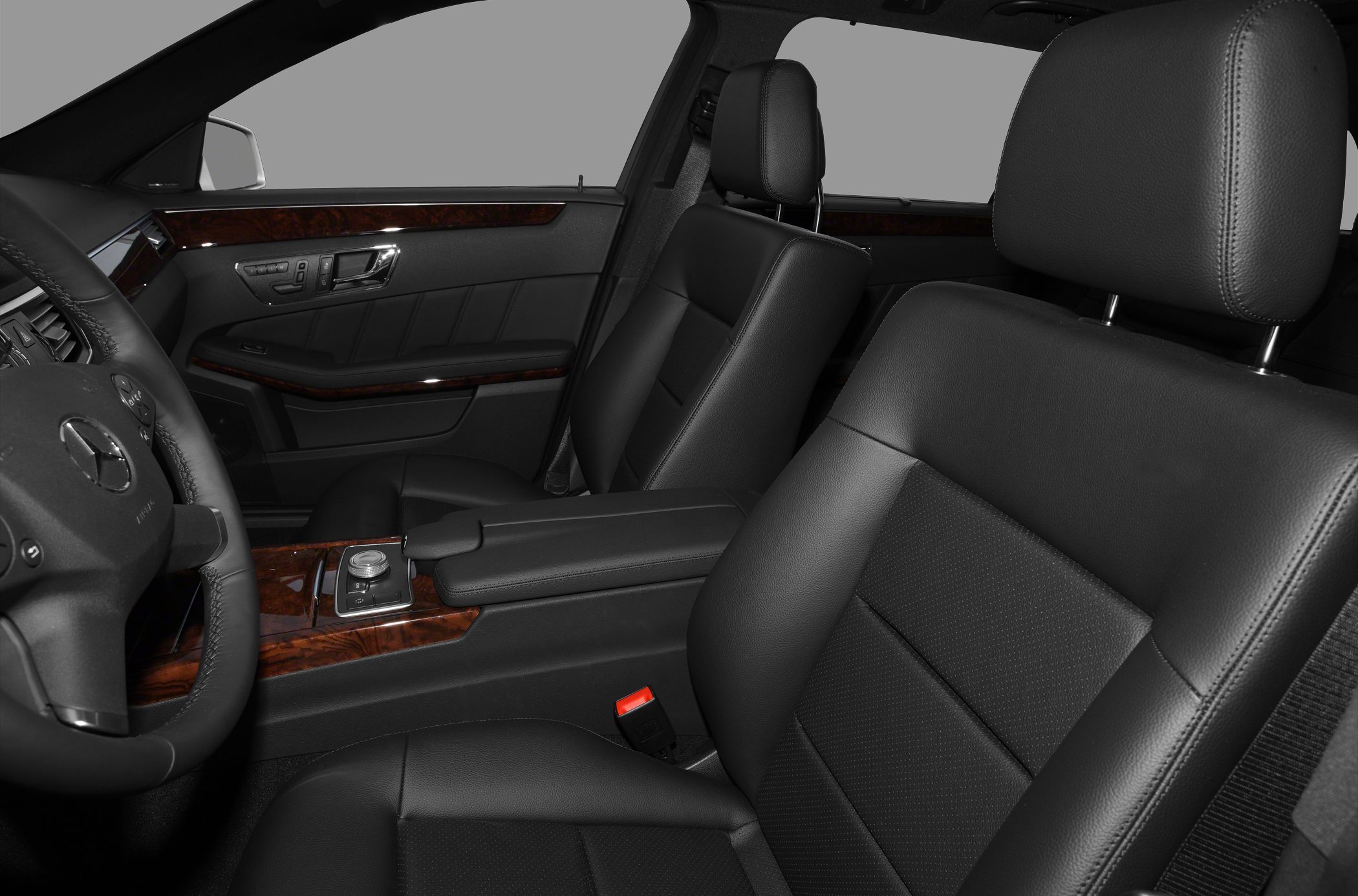 Black leather seats and wood trim with modern control panel
