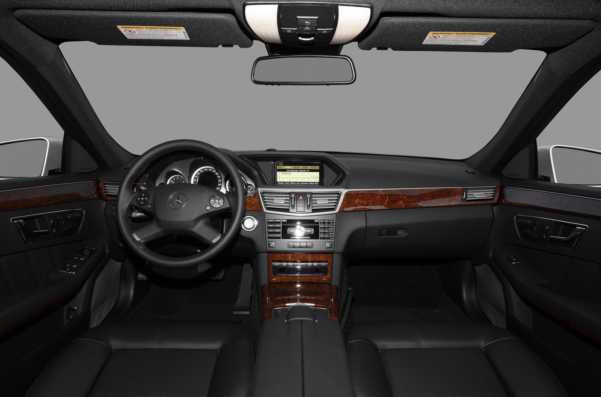 Interior dashboard and steering wheel with wood trim and advanced controls