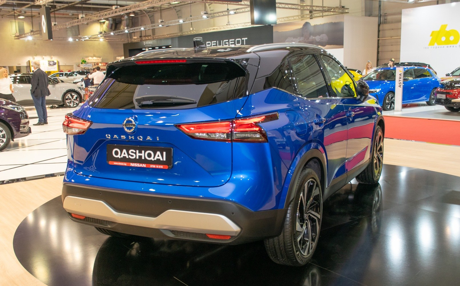 Rear view of a blue SUV with sleek taillights and modern design.