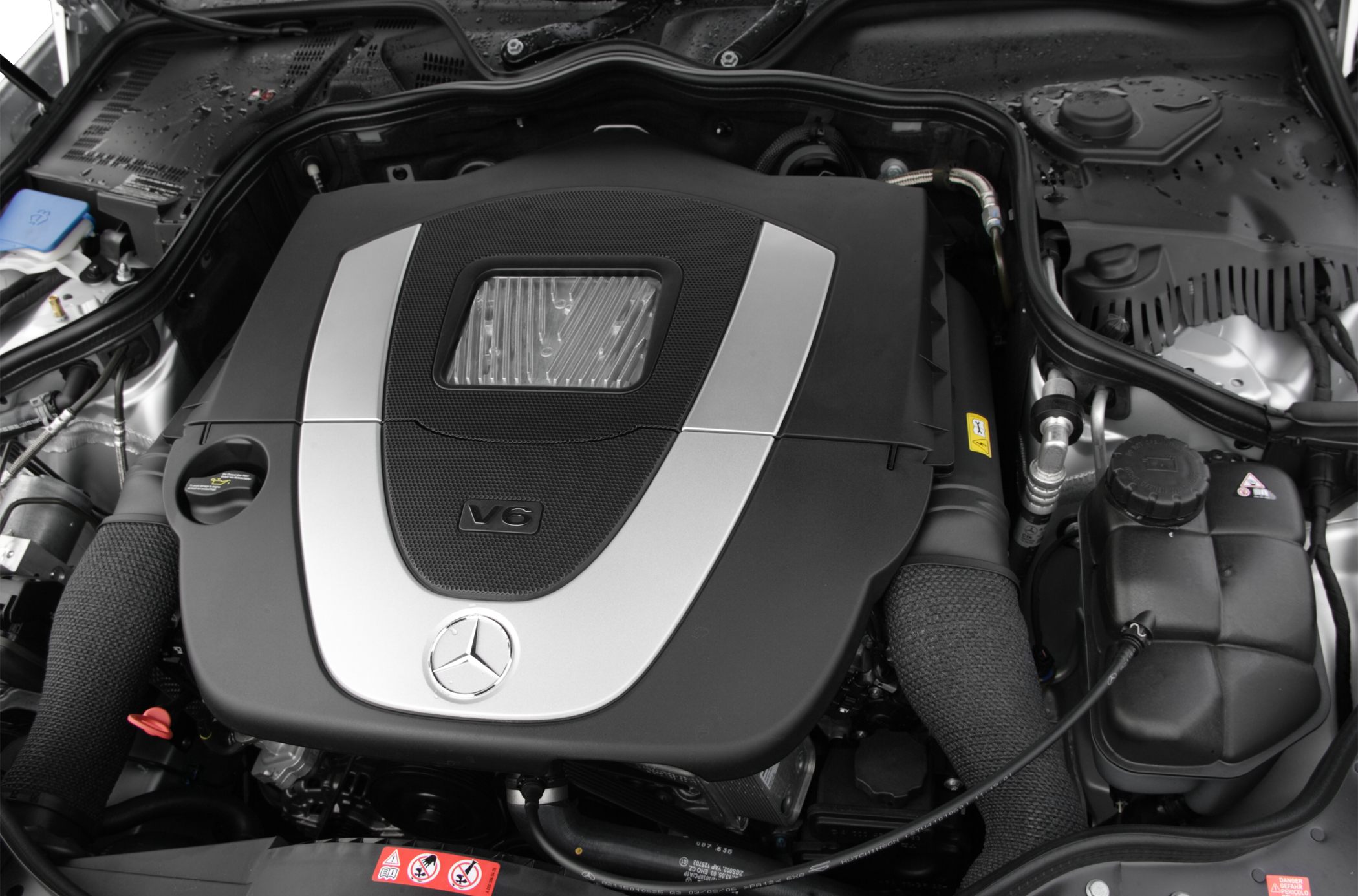 Close-up of a V6 engine with Mercedes emblem and engine cover