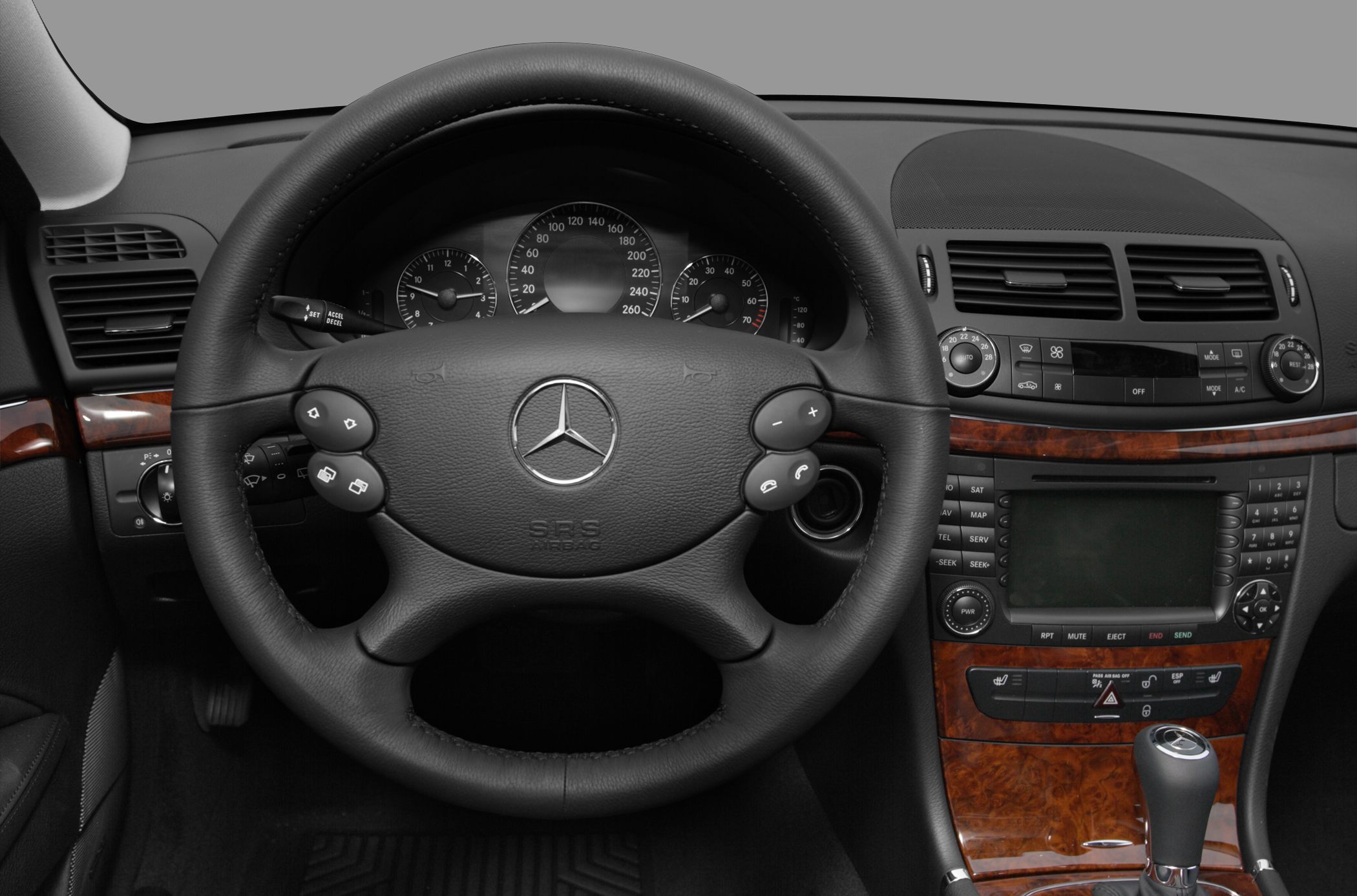 Steering wheel and dashboard with wood trim and console controls