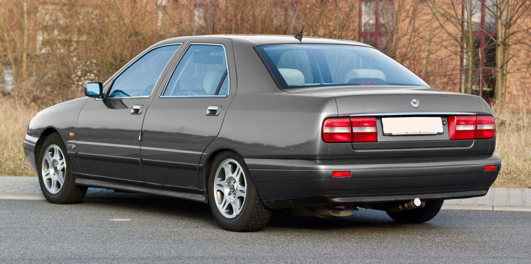 Rear and side profile of a four-door sedan with alloy wheels