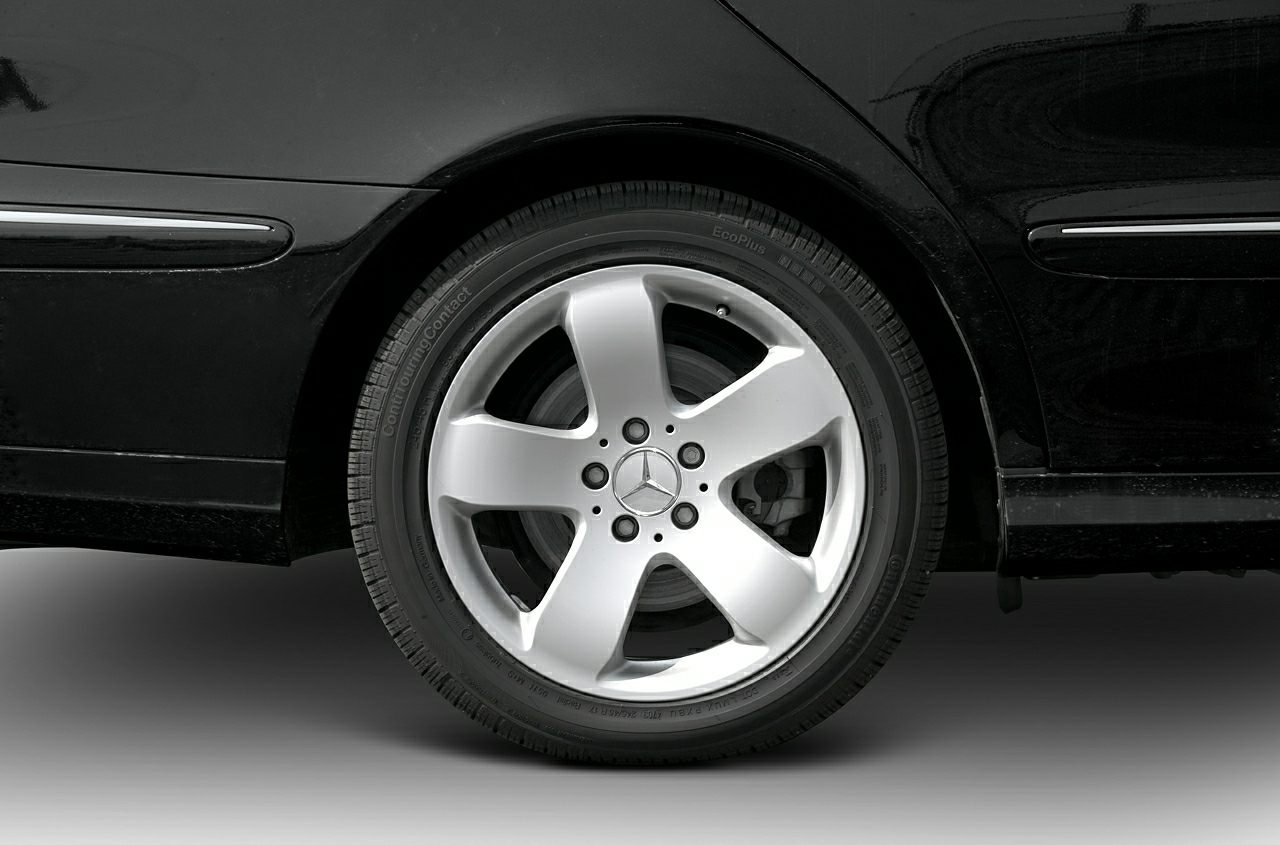 Five-spoke alloy wheel and black tire closeup