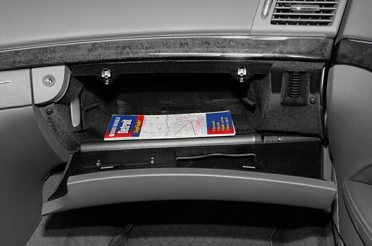 Open glove compartment inside car dashboard with storage space
