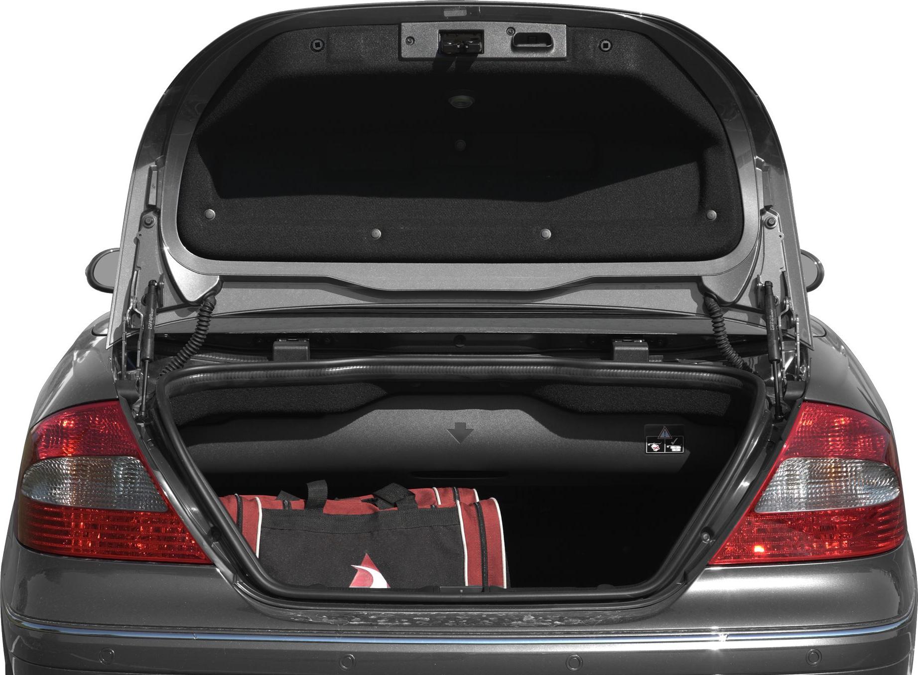 Open trunk with a red and black bag inside, rear lights visible