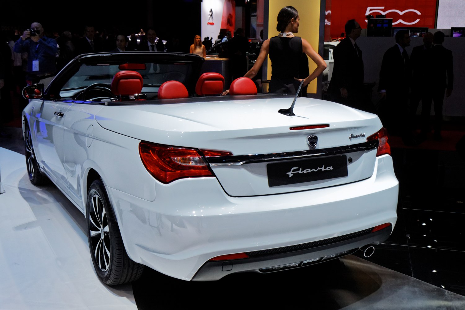 Rear view of a white convertible with red interior seats