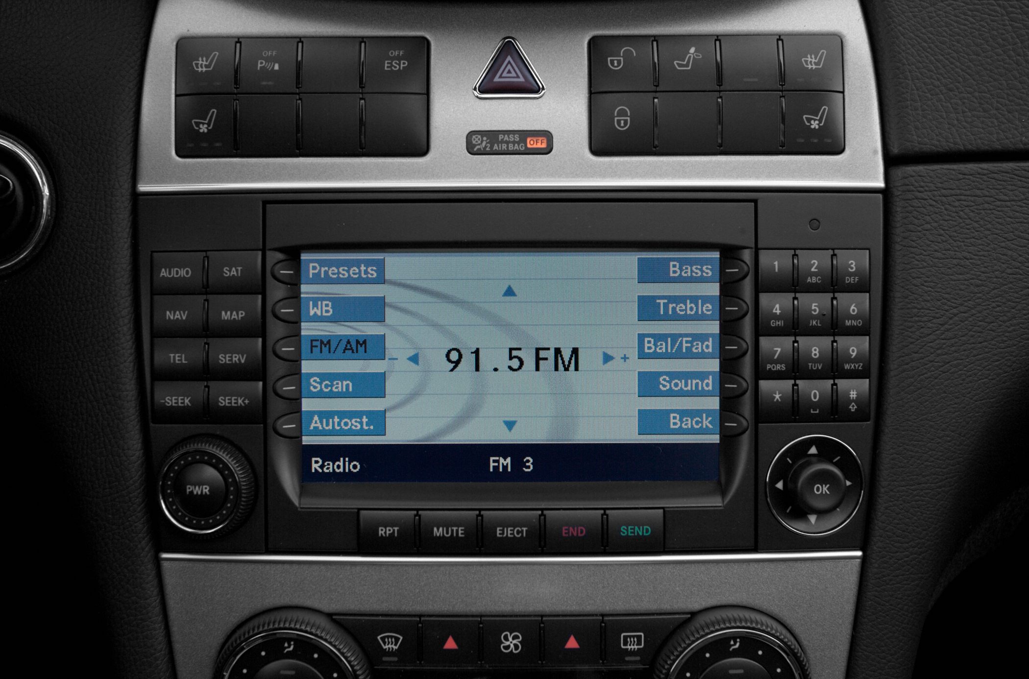 Car audio system and dashboard controls with radio interface and climate control knobs