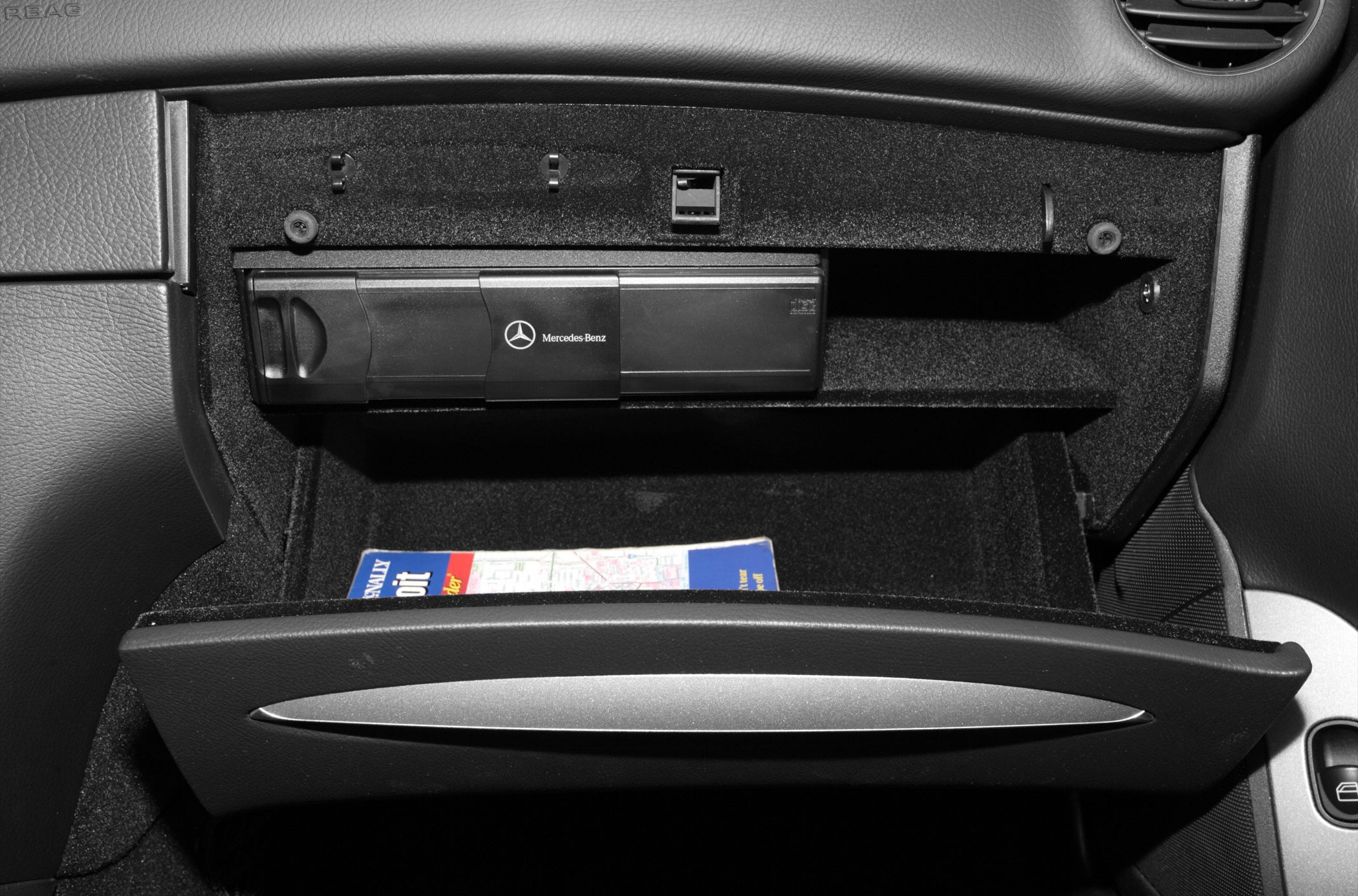 Glove compartment with built-in CD changer and storage space.
