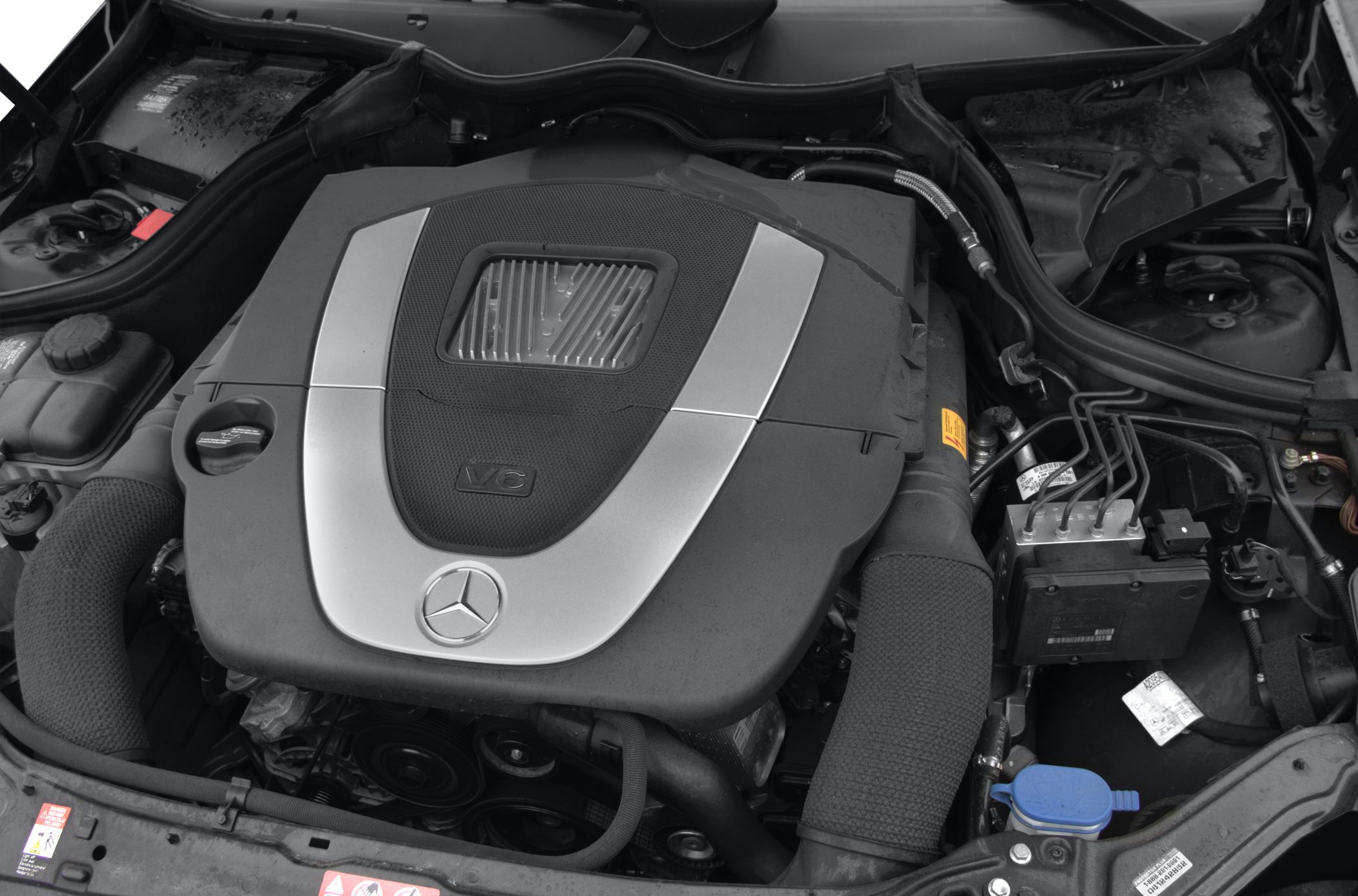 Mercedes-Benz V6 engine with distinctive engine cover and surrounding components