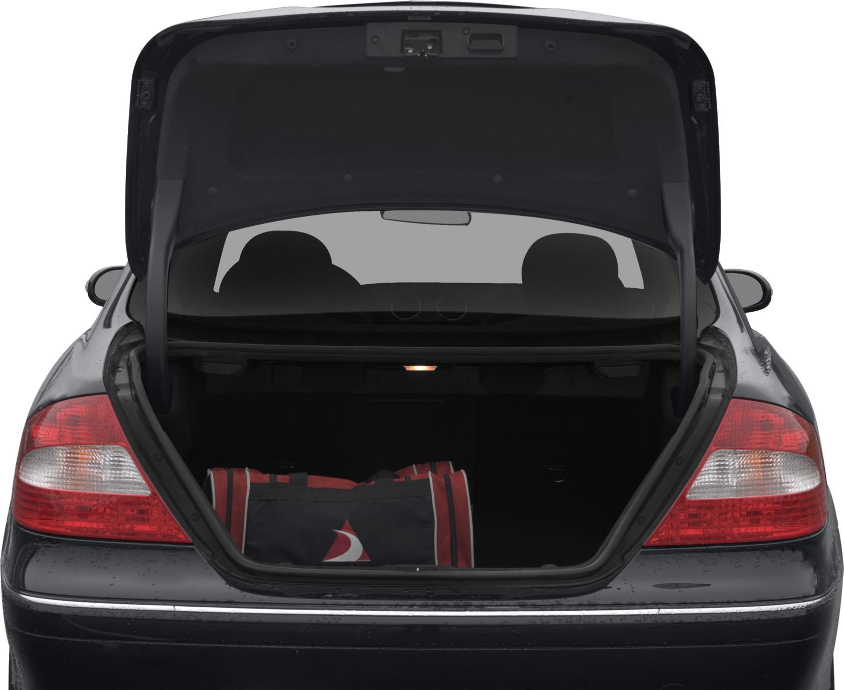 Open trunk with red and black duffel bag, illuminated interior light, rear tail lights visible
