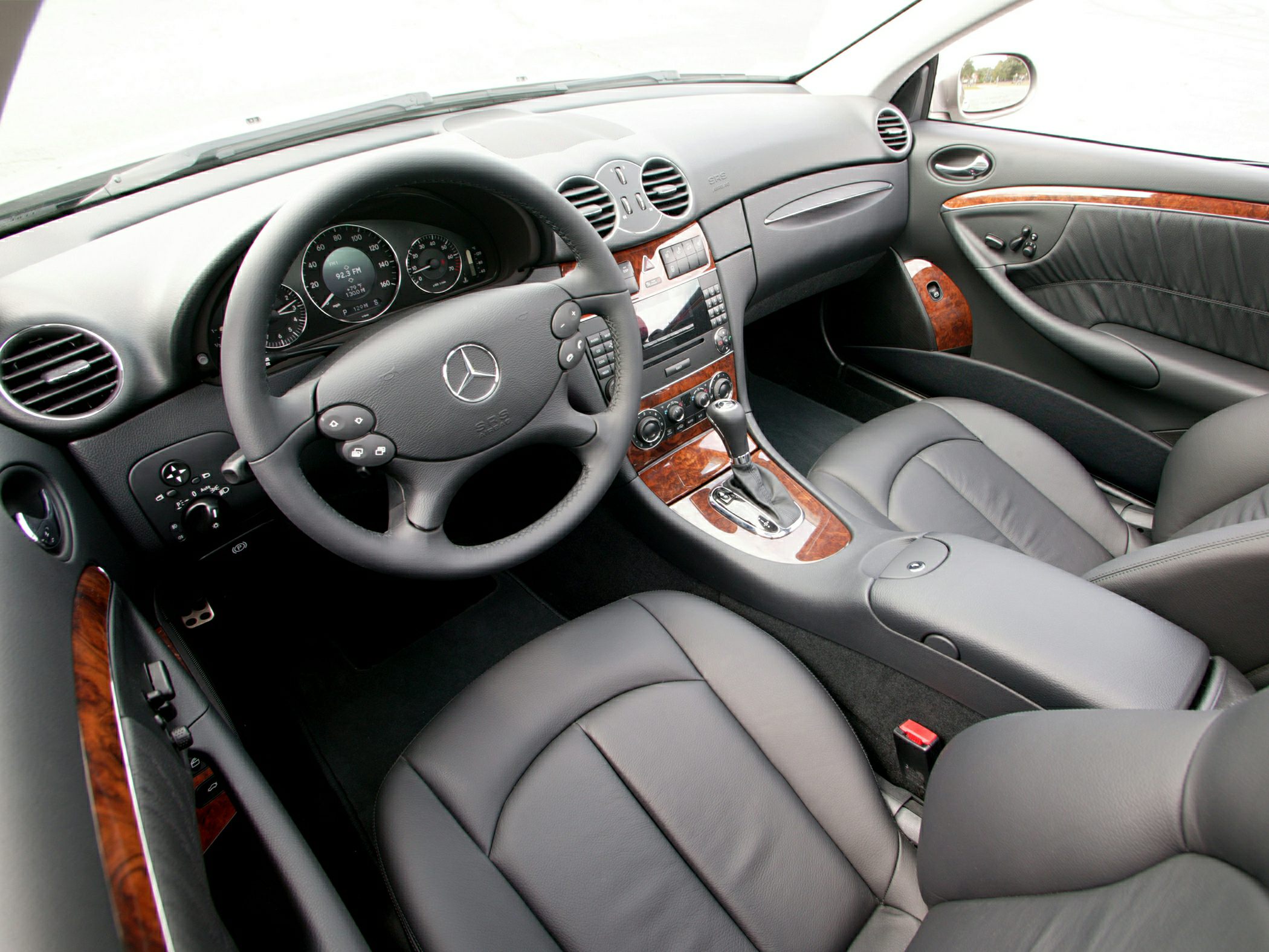 Leather seats and wood trim interior with multi-functional steering wheel