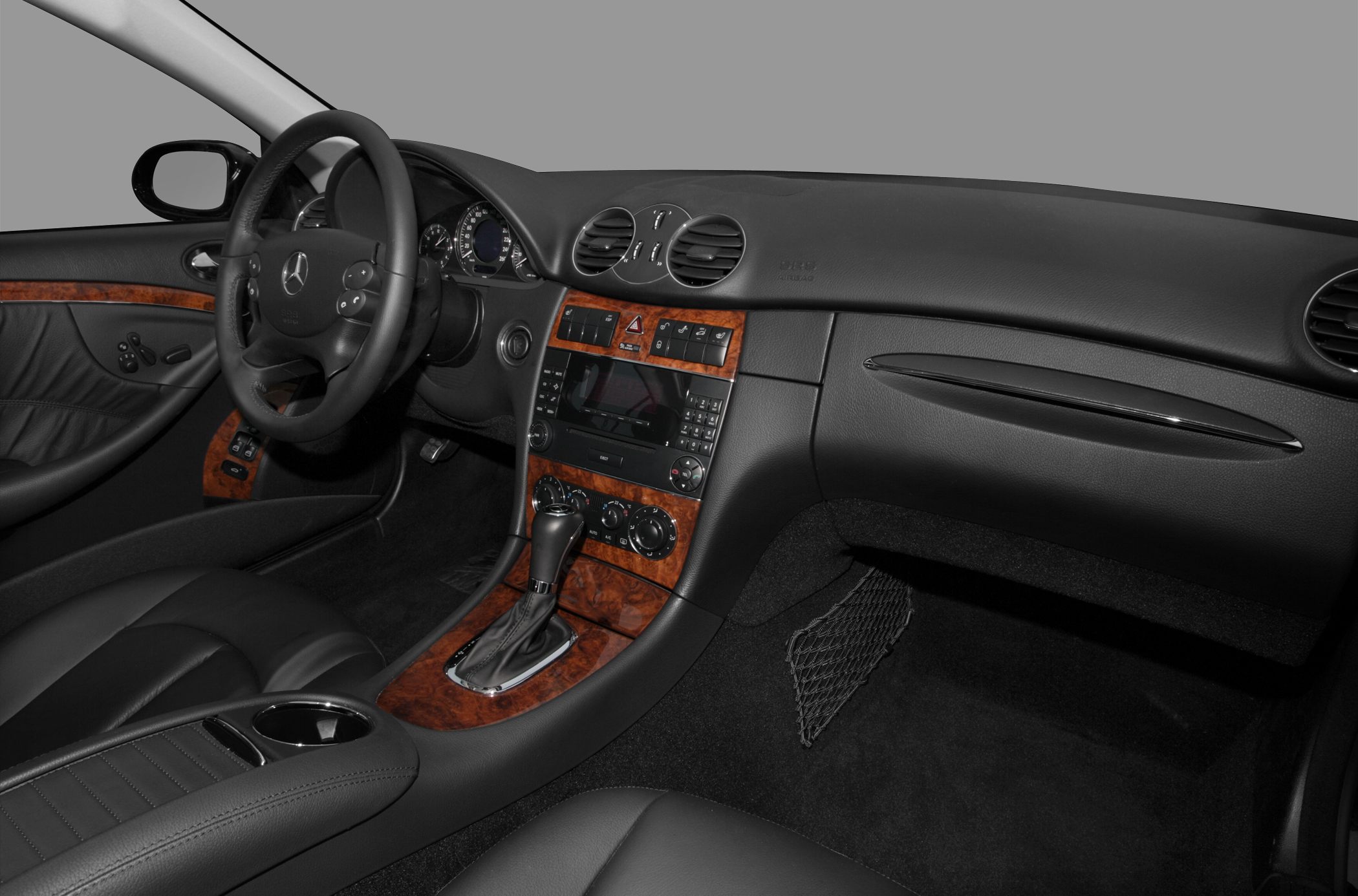 Wood-trimmed dashboard and automatic gear shift in luxury car interior