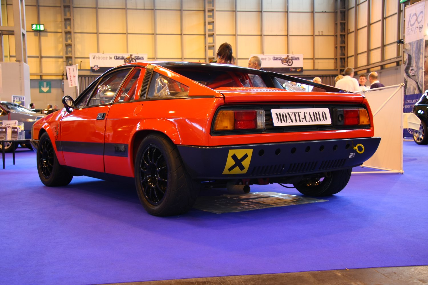 Rear view of a sporty mid-engine coupe with racing aesthetics
